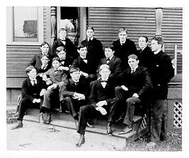 old black and white photograph of men posing on steps