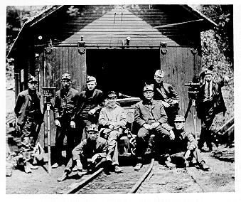 old black and white photograph of Mining engineering at mine entrance