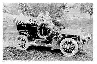 Two students in an early automobile