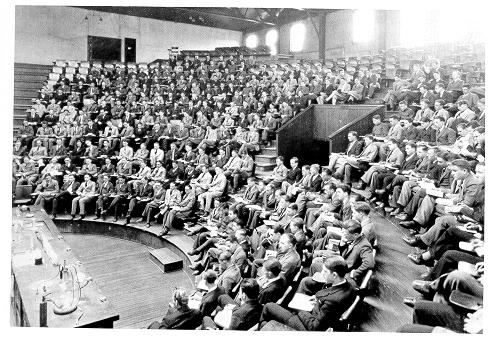 old black and white photograph of students in semi-circular lecture hall