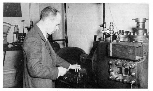 old black and white photograph of Paul Schweitzer with deisel equipment