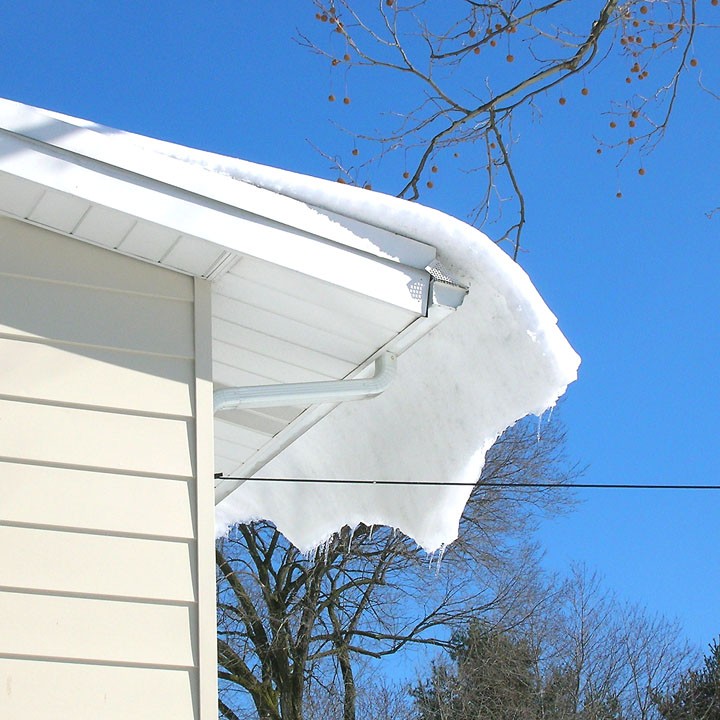 View of snow builds up on the low-pitched roof from outside