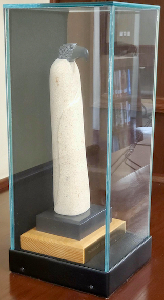 The Sentinel, by Ojibwe artist Gordon van Wert, sculpture in a glass case